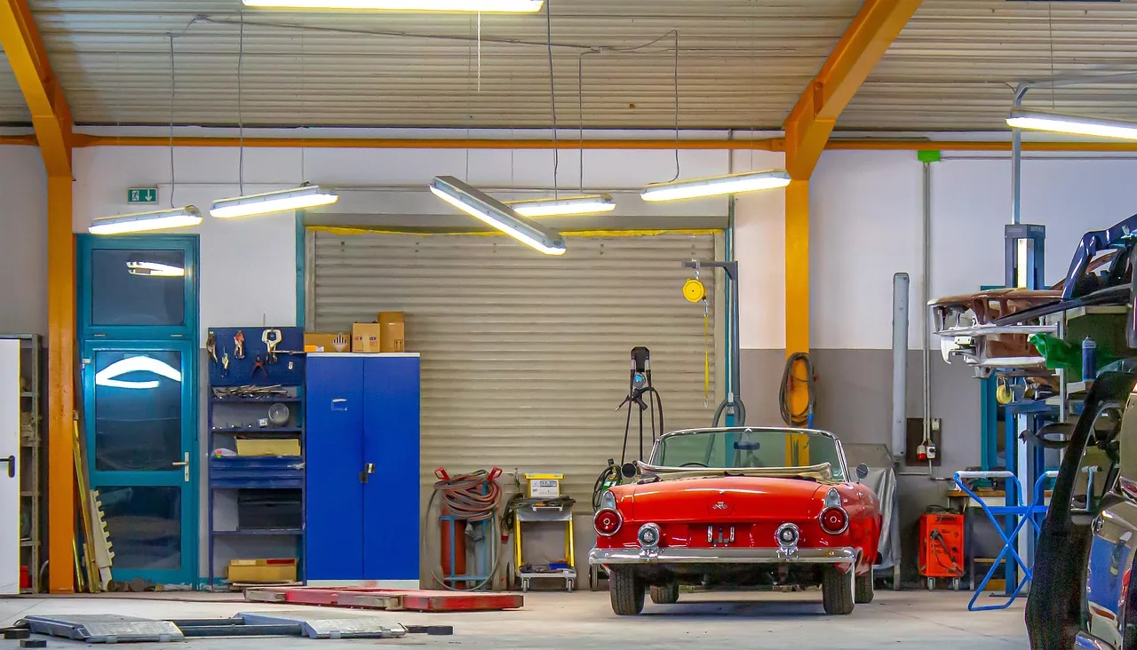 A car inside an open service bay