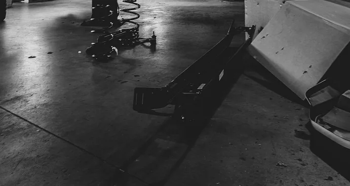 A coil spring and shop floor under a vehicle