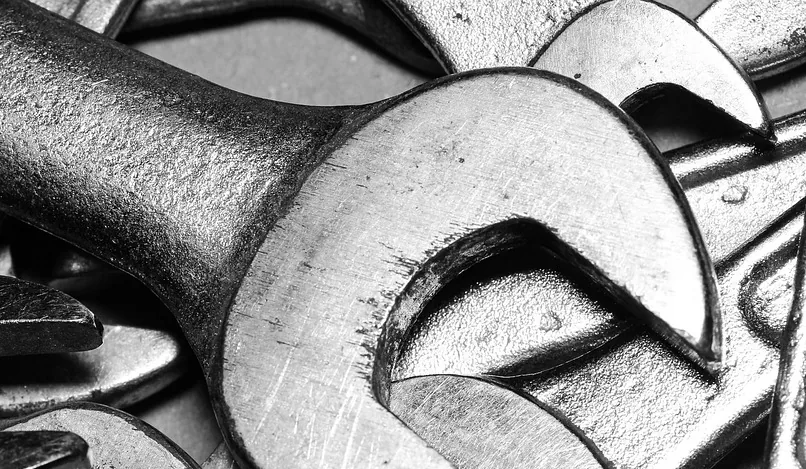 Open wrench jaws on a shop bench