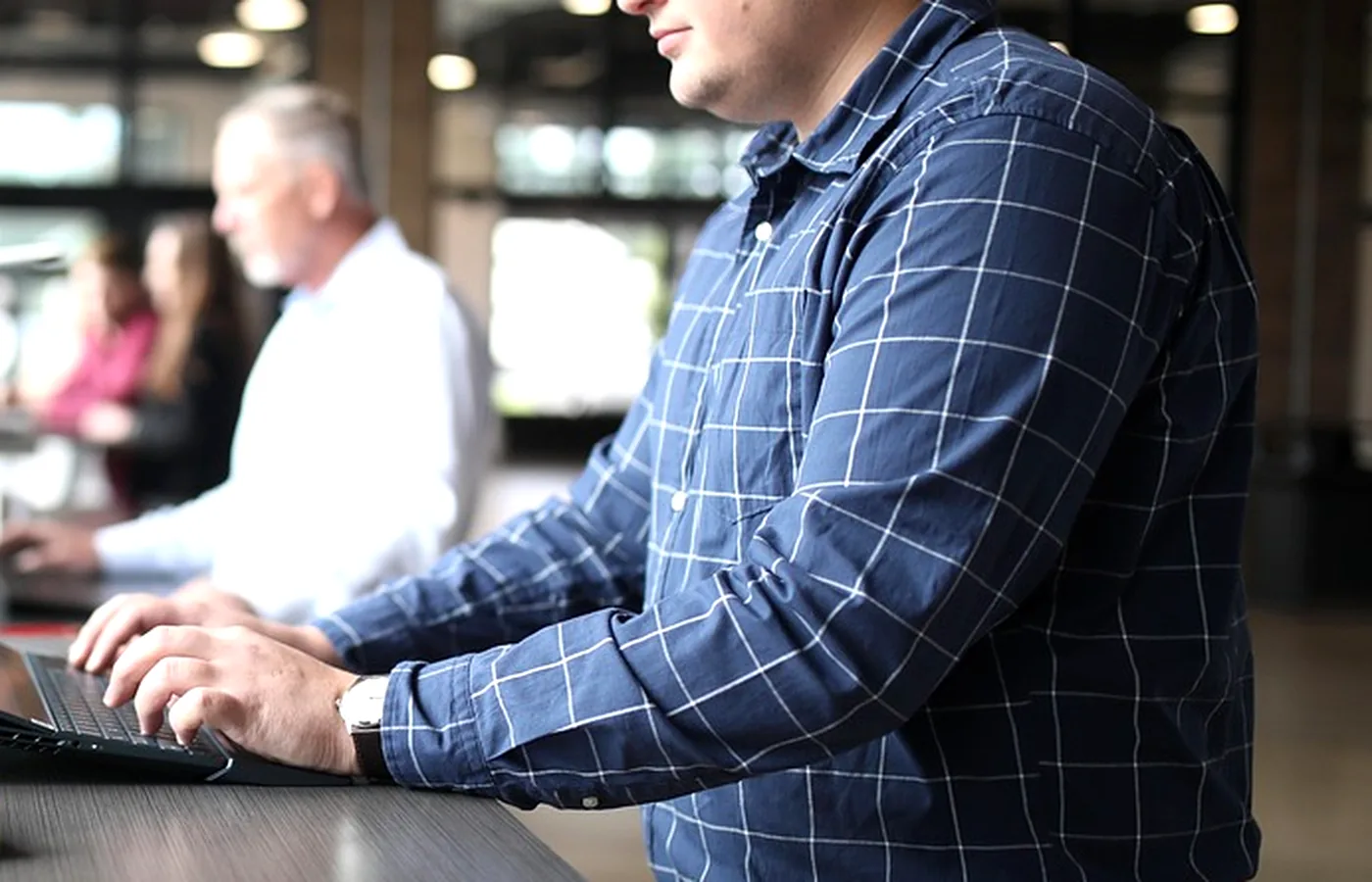 A person working at two screens
