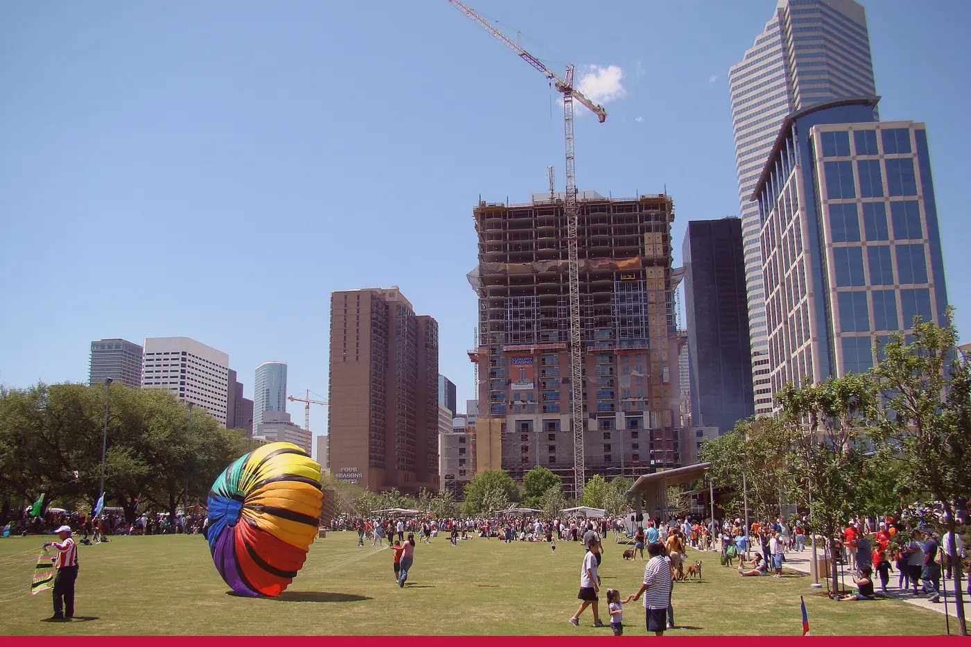 A lawn and the towers at Discovery Green