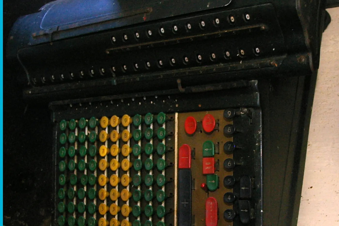 An adding machine with red, yellow, and green keys