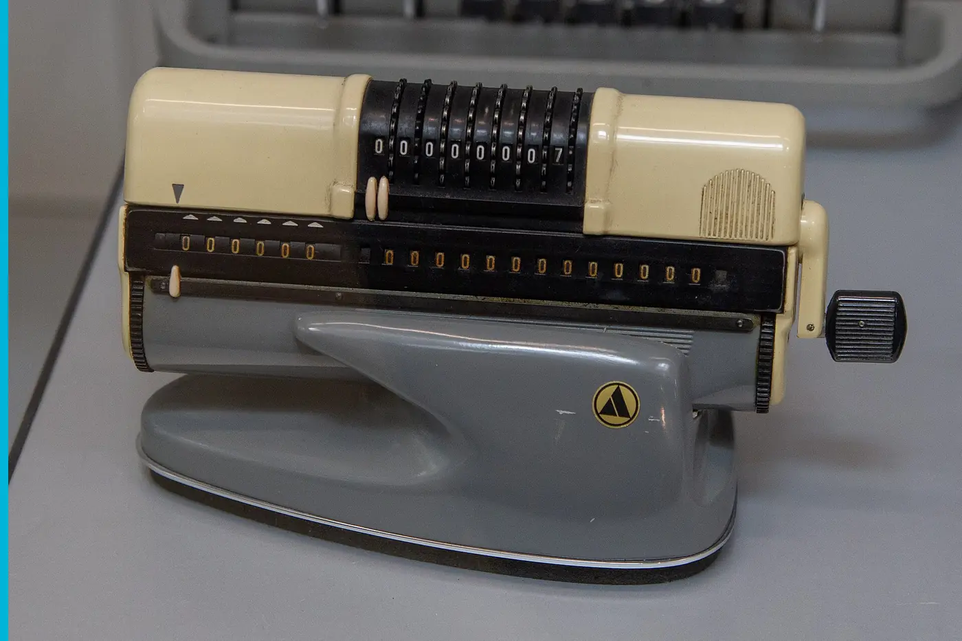 A small desktop calculator, the tape slot on the side