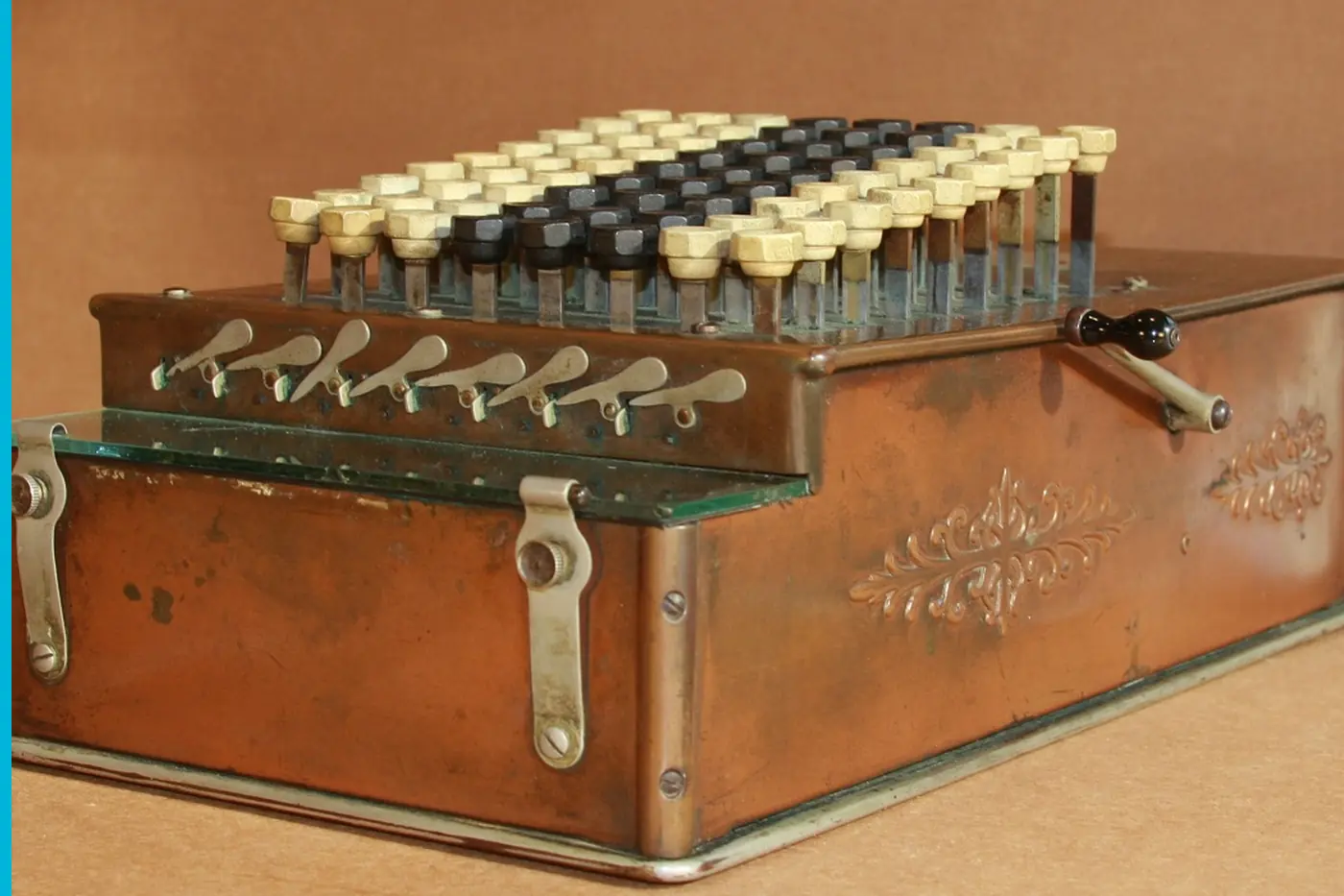 A Comptometer in a wooden case, rows of keys on top