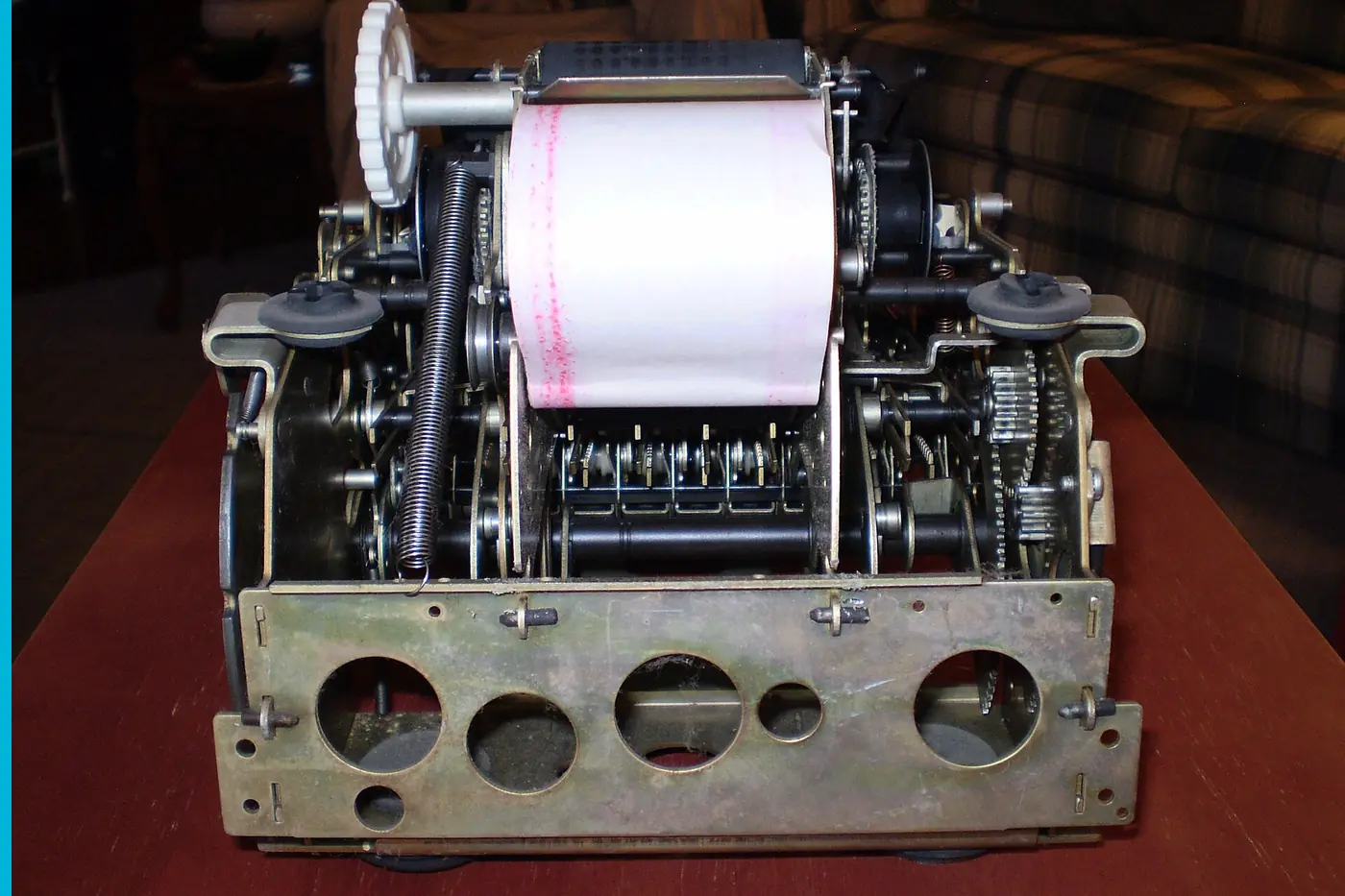 The works of an adding machine, number bars and gears open