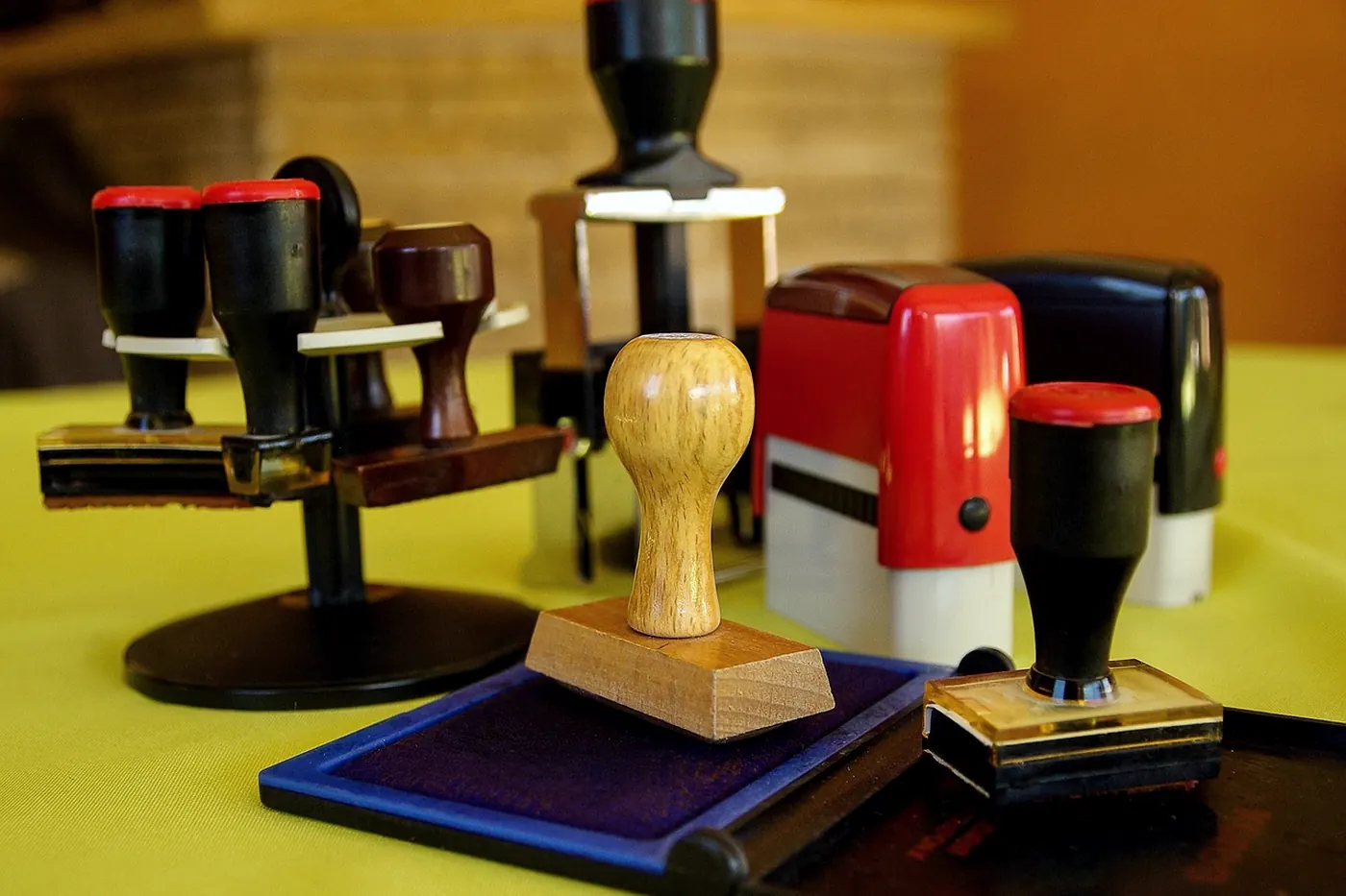 Rubber stamps lined up on a yellow cloth