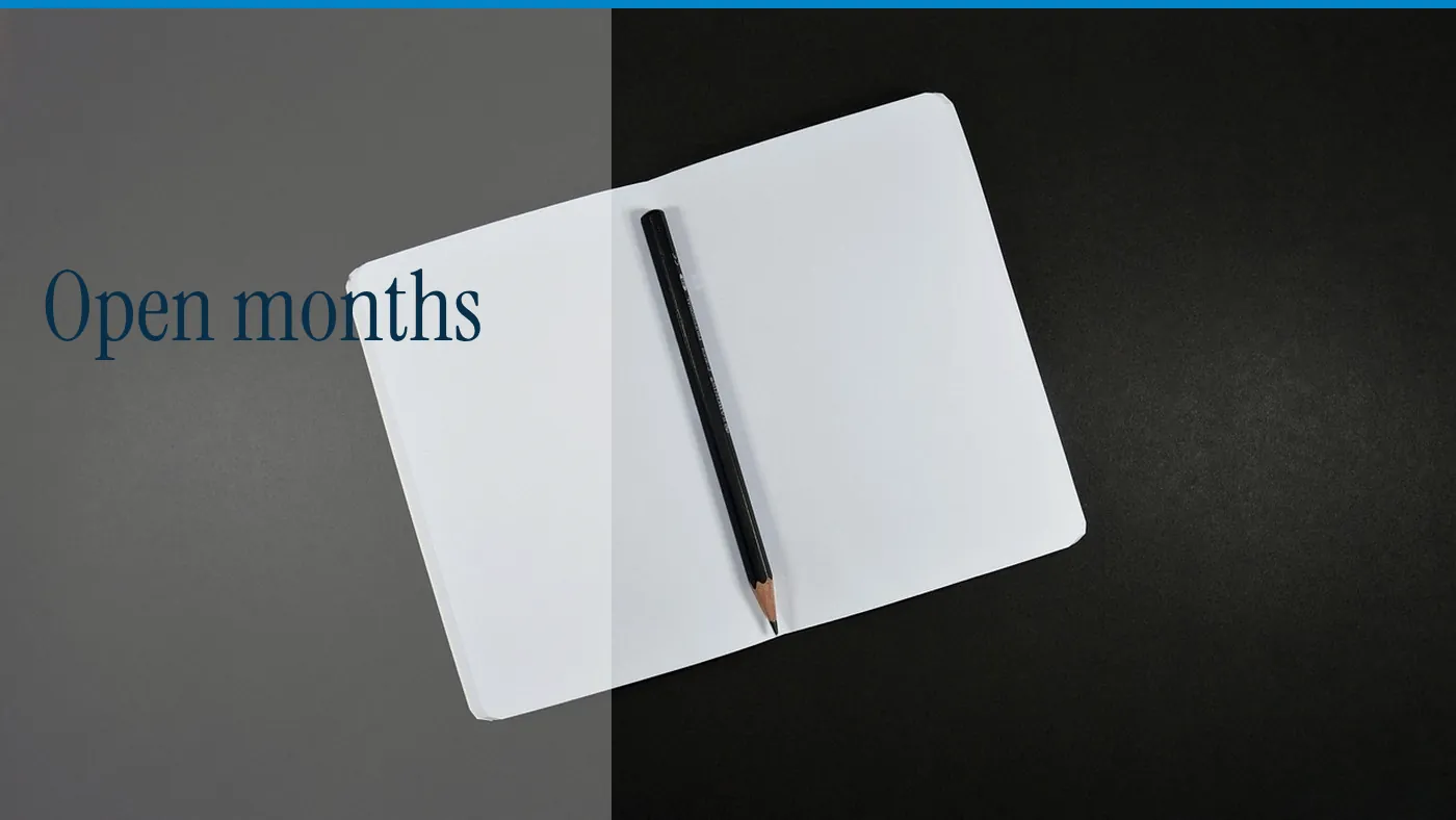 An open notebook and a pencil, with the words Open months in large type