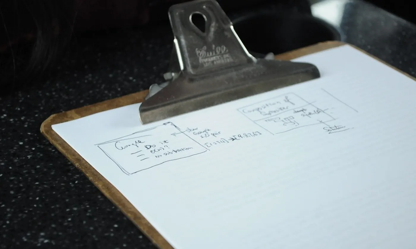 Handwritten notes held on a clipboard
