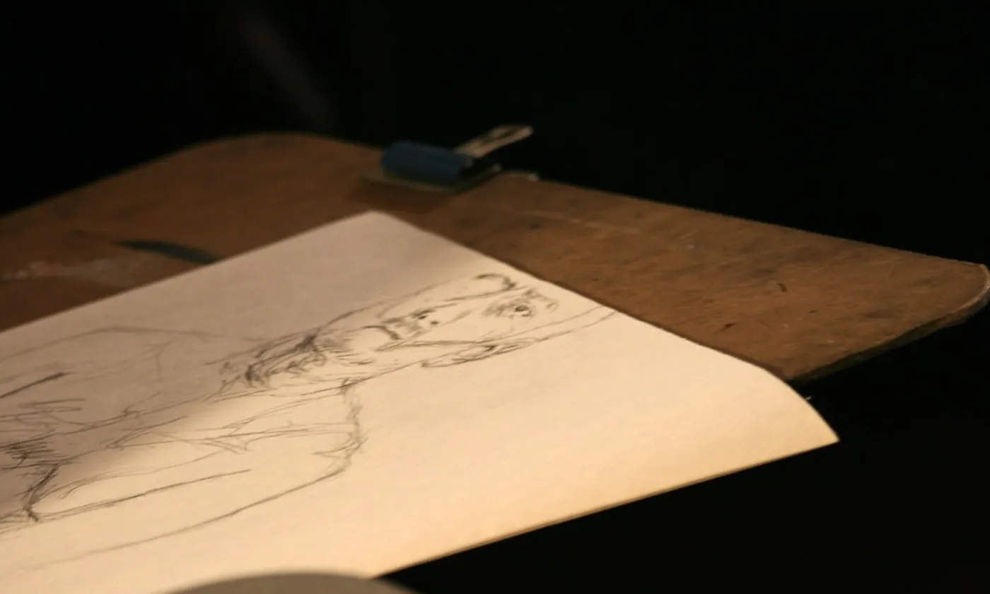 A clipboard with a sketch on the top sheet