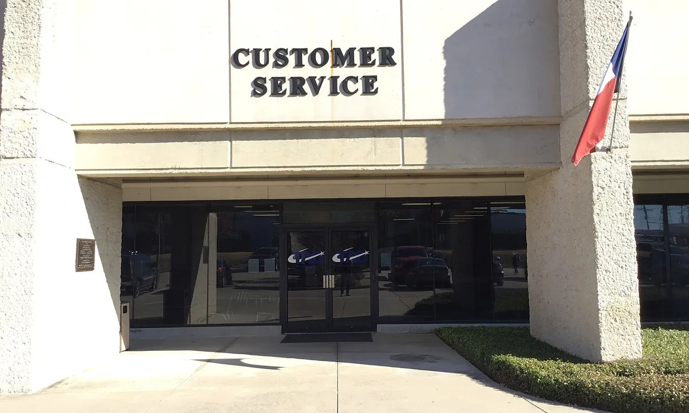The customer service entrance of the Tarrant Appraisal District with a Texas flag beside it
