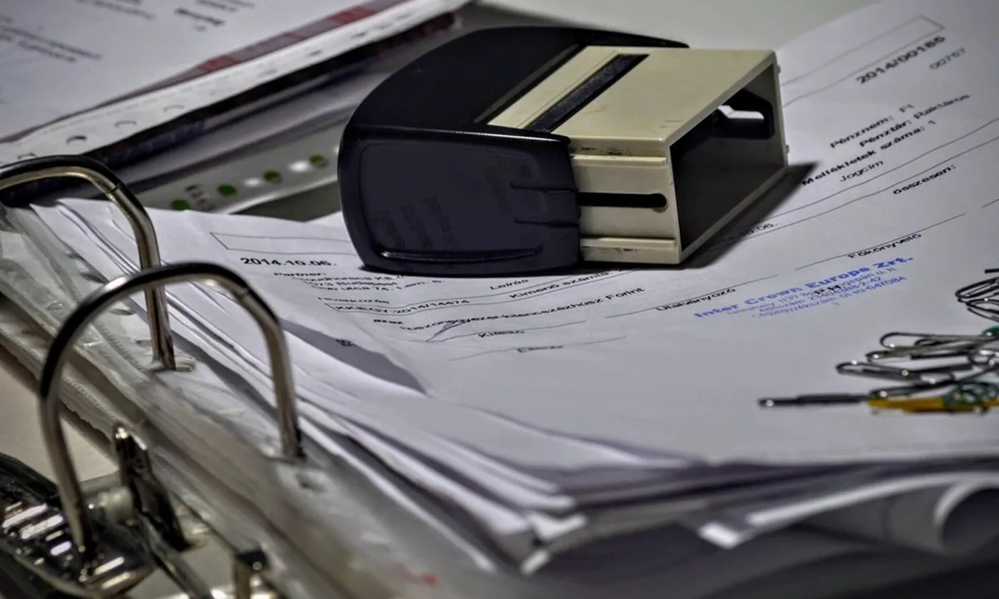 An open ring binder full of printed statements