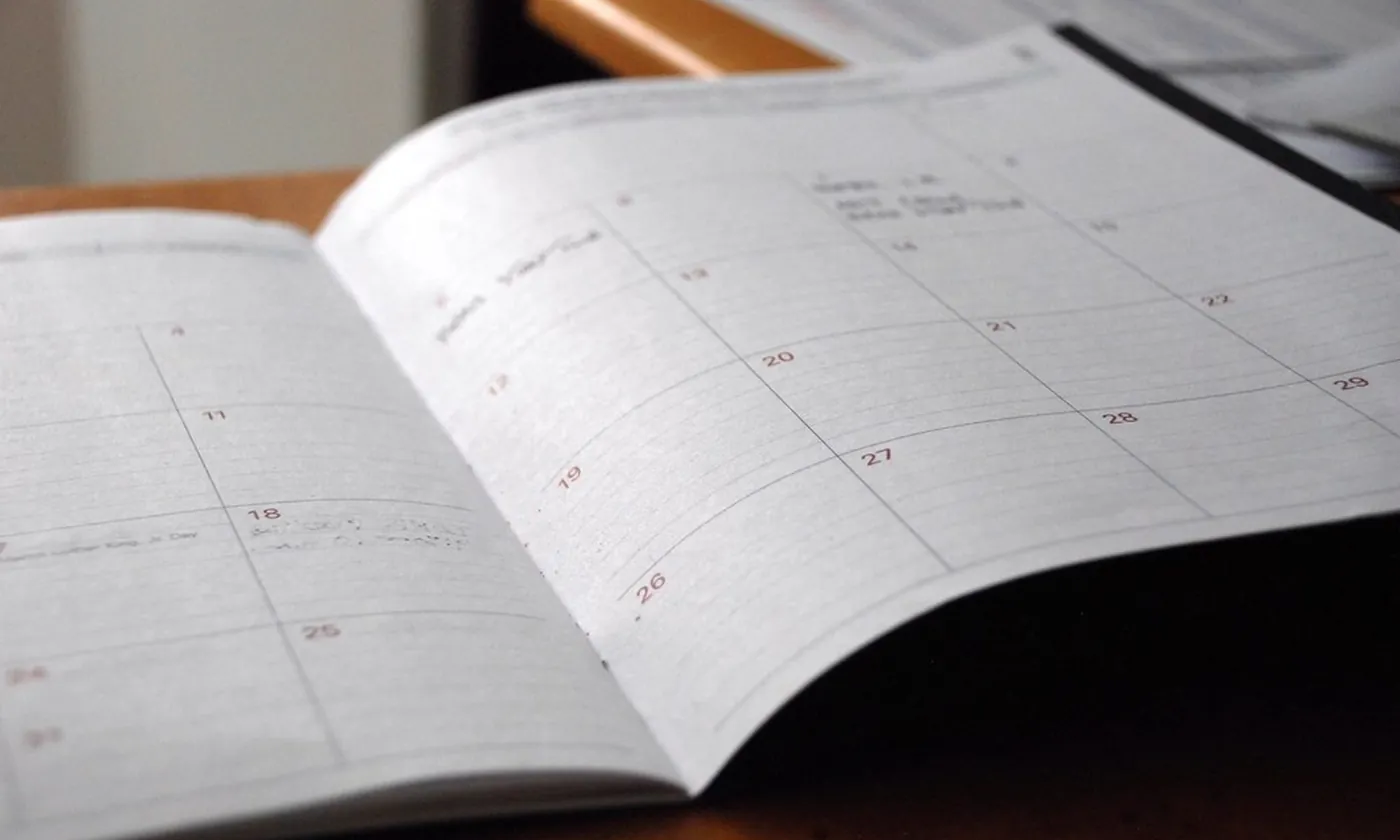 An open month planner with short notes on a few dates