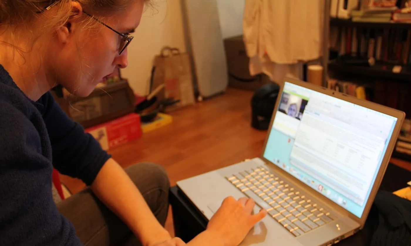 A person at home on a video call on a laptop