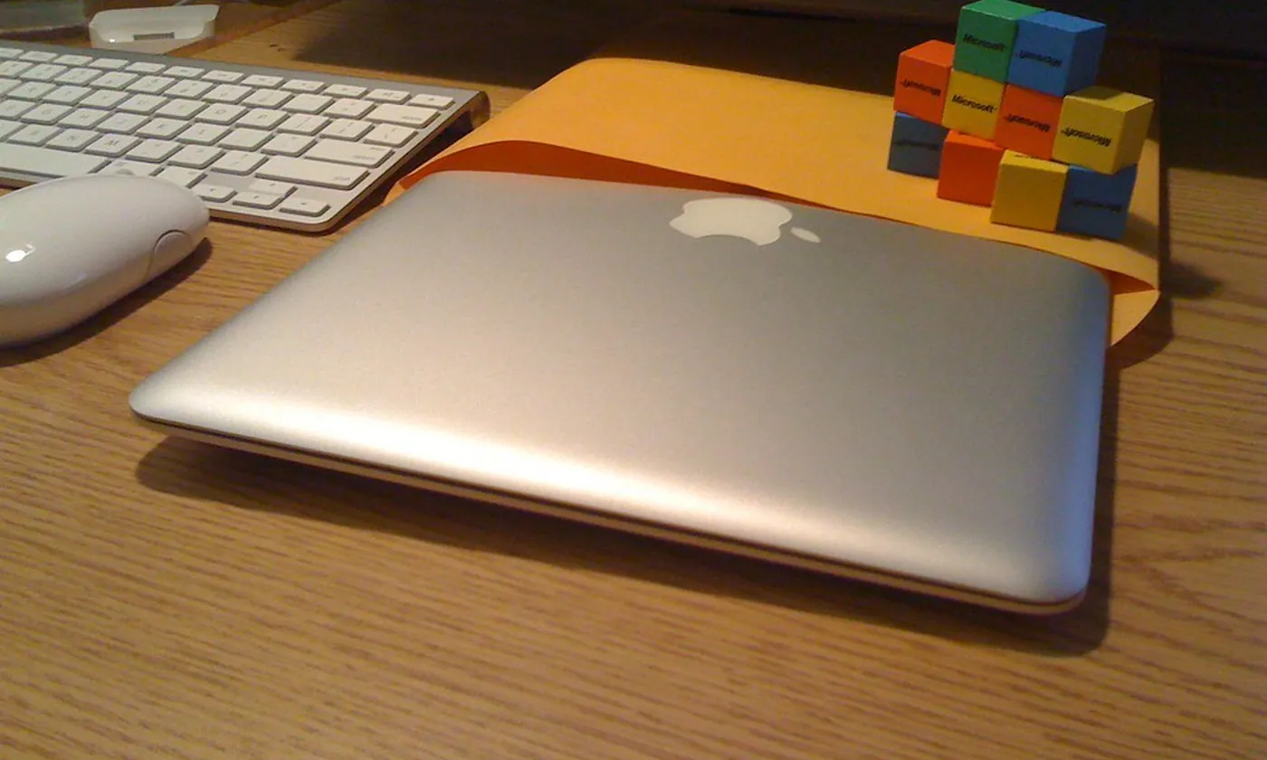 A closed laptop resting on a large envelope on a desk
