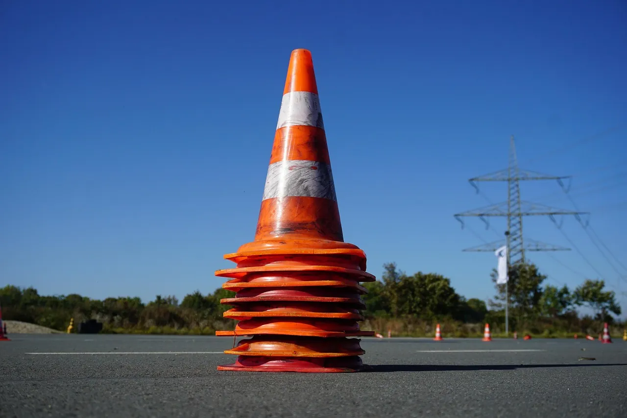 An orange traffic cone on pavement
