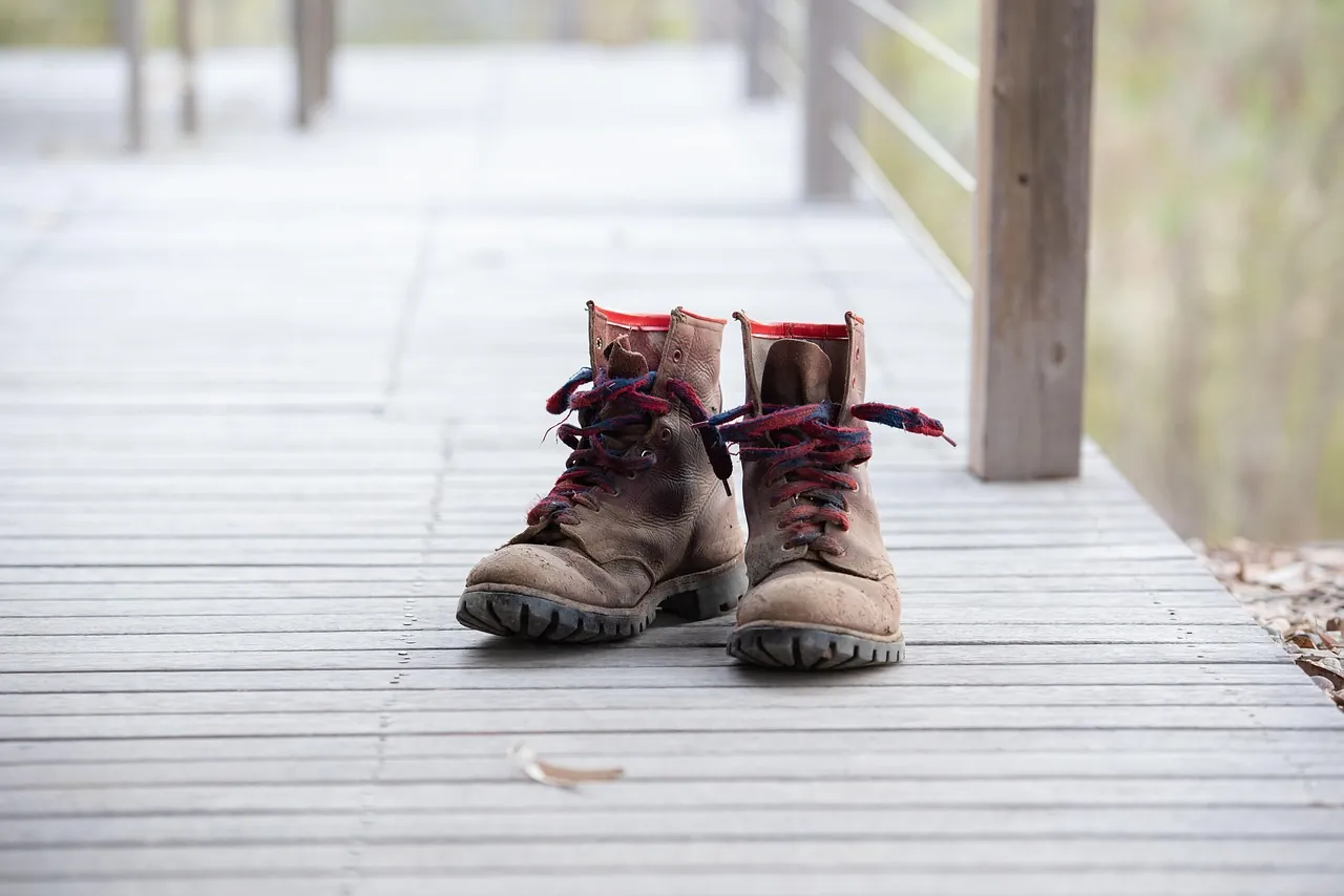 Worn work boots on a wooden deck