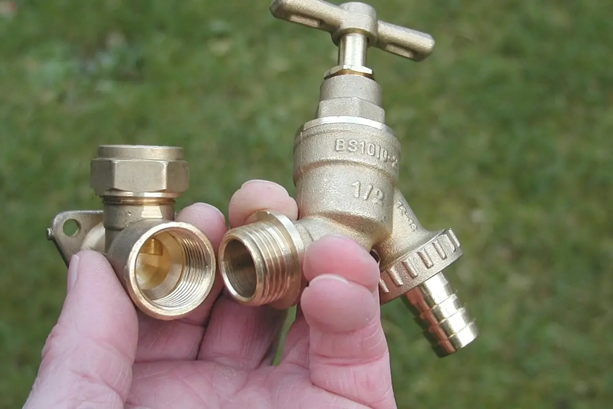 Brass plumbing valves held in one hand