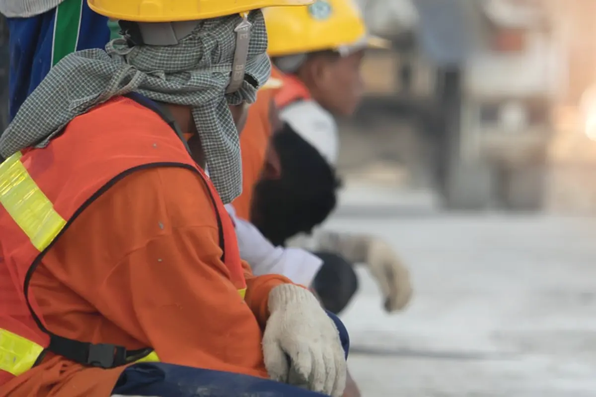 A crew in hard hats beside fresh steel