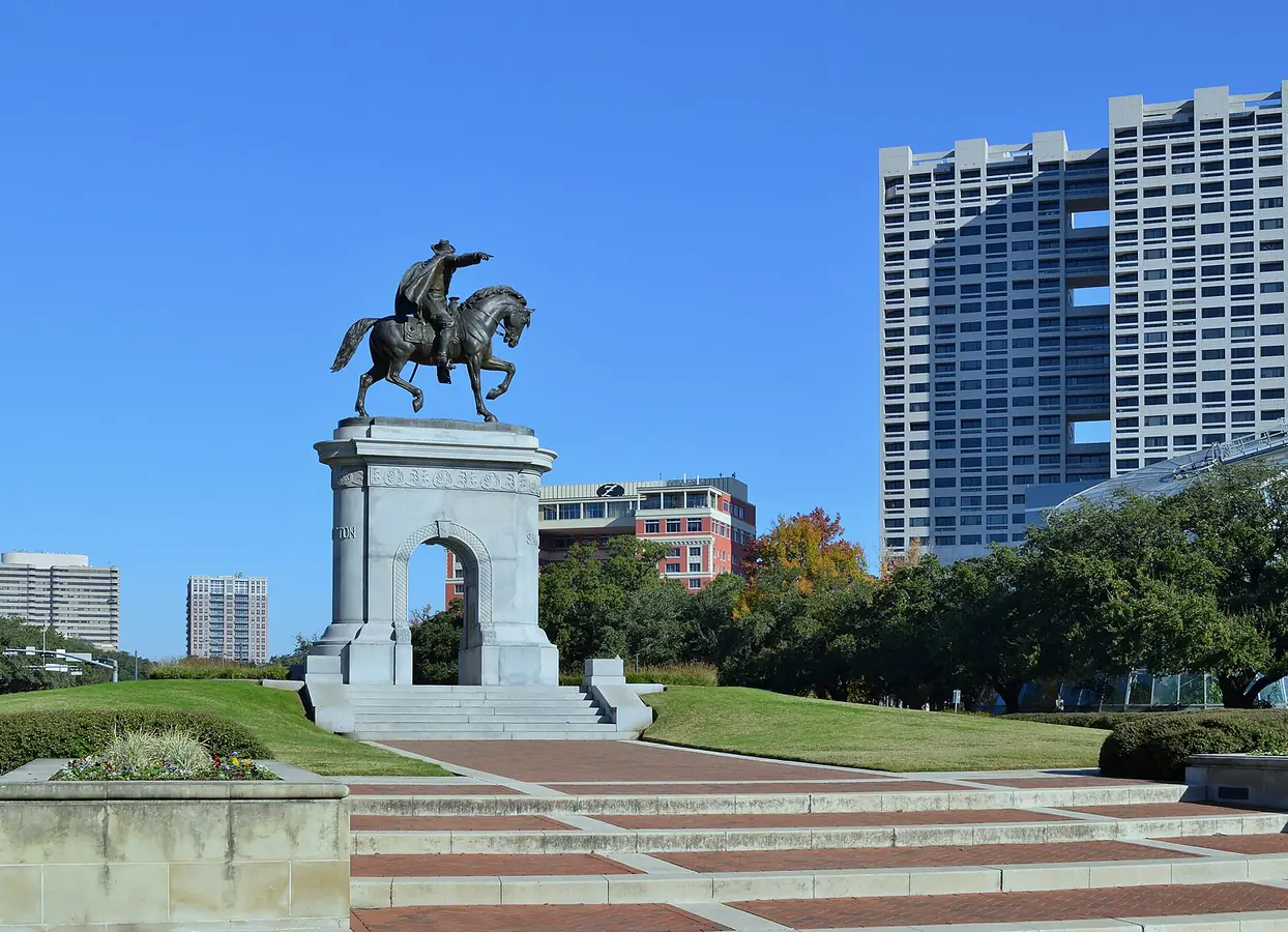 A tall monument among trees in a park