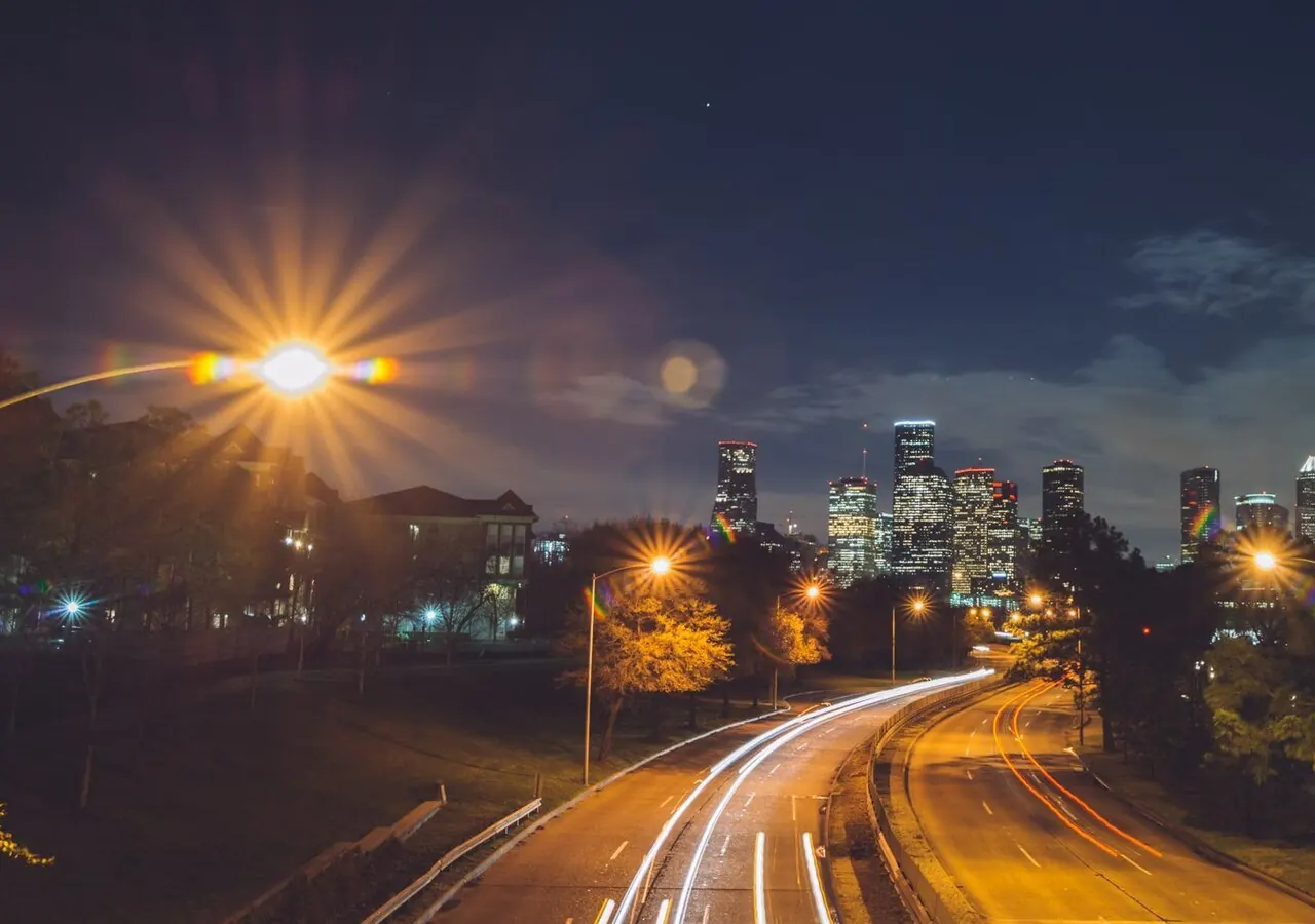 Night freeway lights toward the downtown towers