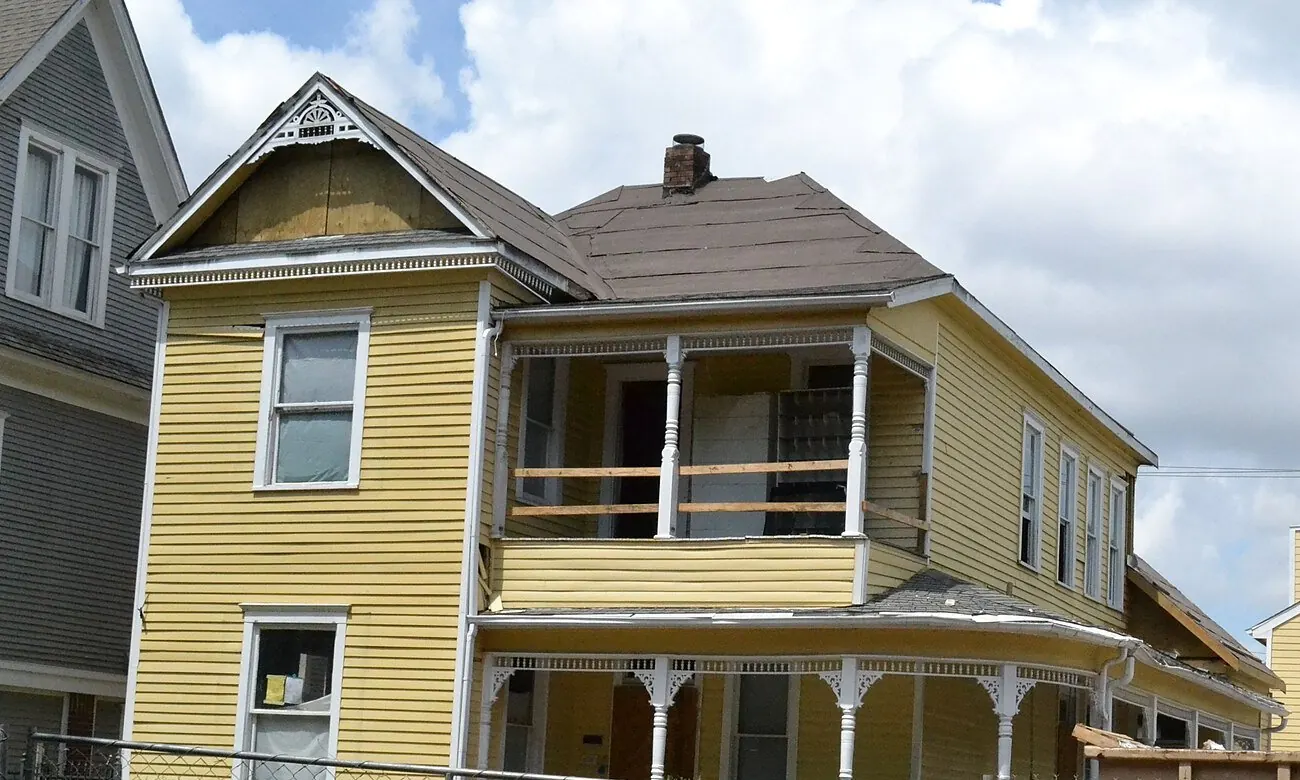 Yellow two-story house with both porches