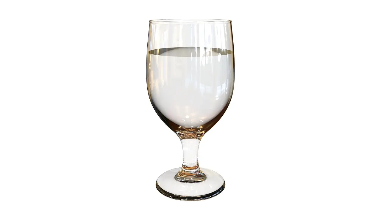 A clear glass of water on a white ground, with no label.