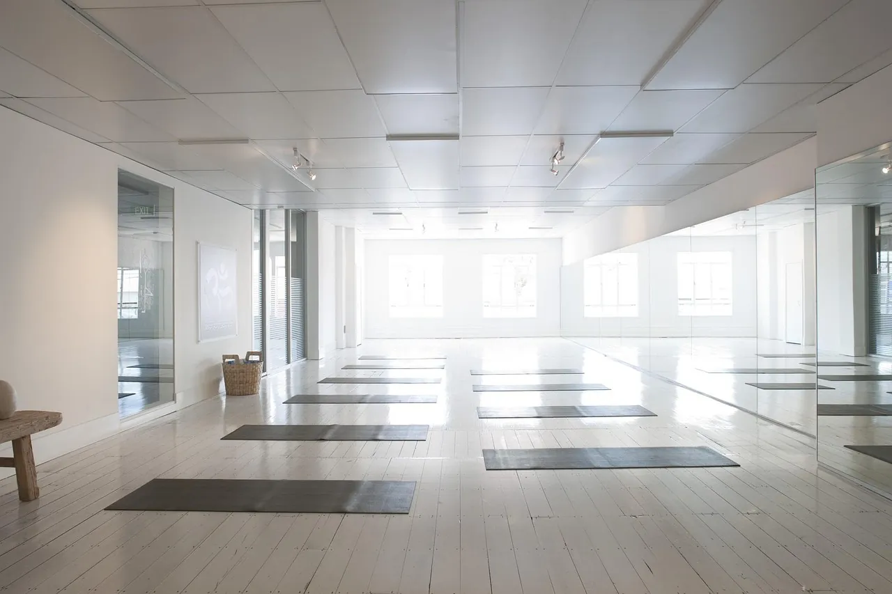 A quiet studio interior in gray light, empty of people and of signs.