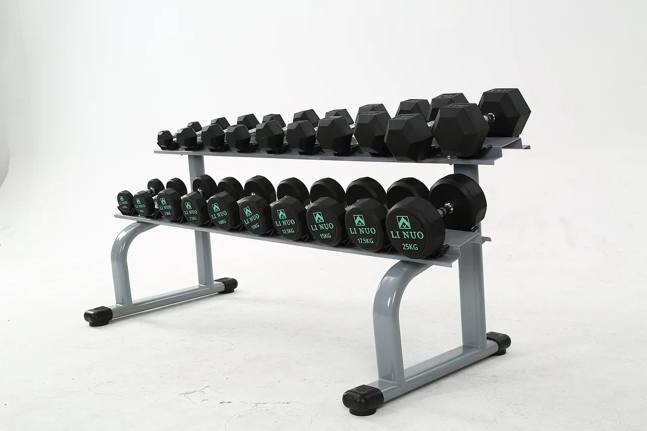 A pair of hex dumbbells on a light floor, with no logo and no number large enough to read.
