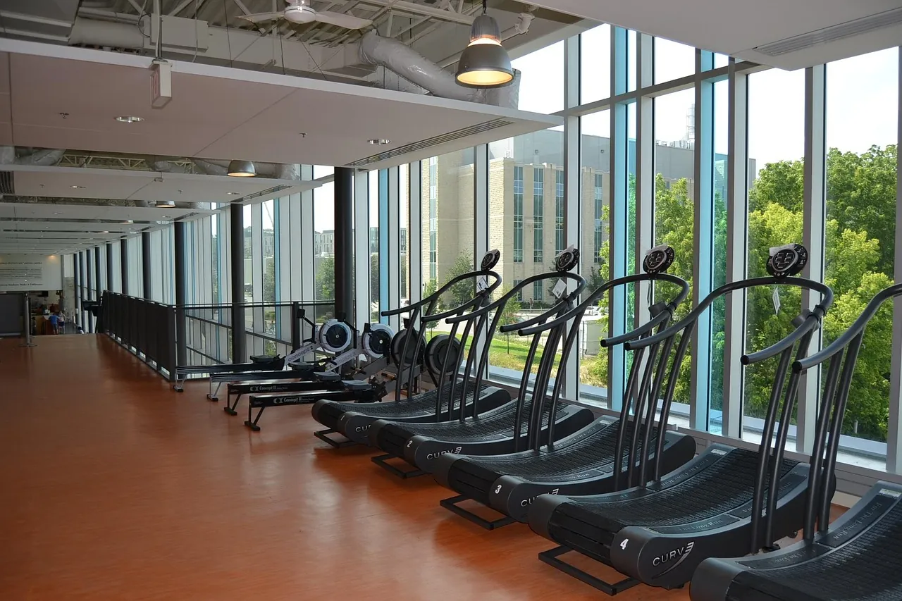 Cardio machines in a gym, seen from the side, with no club name.