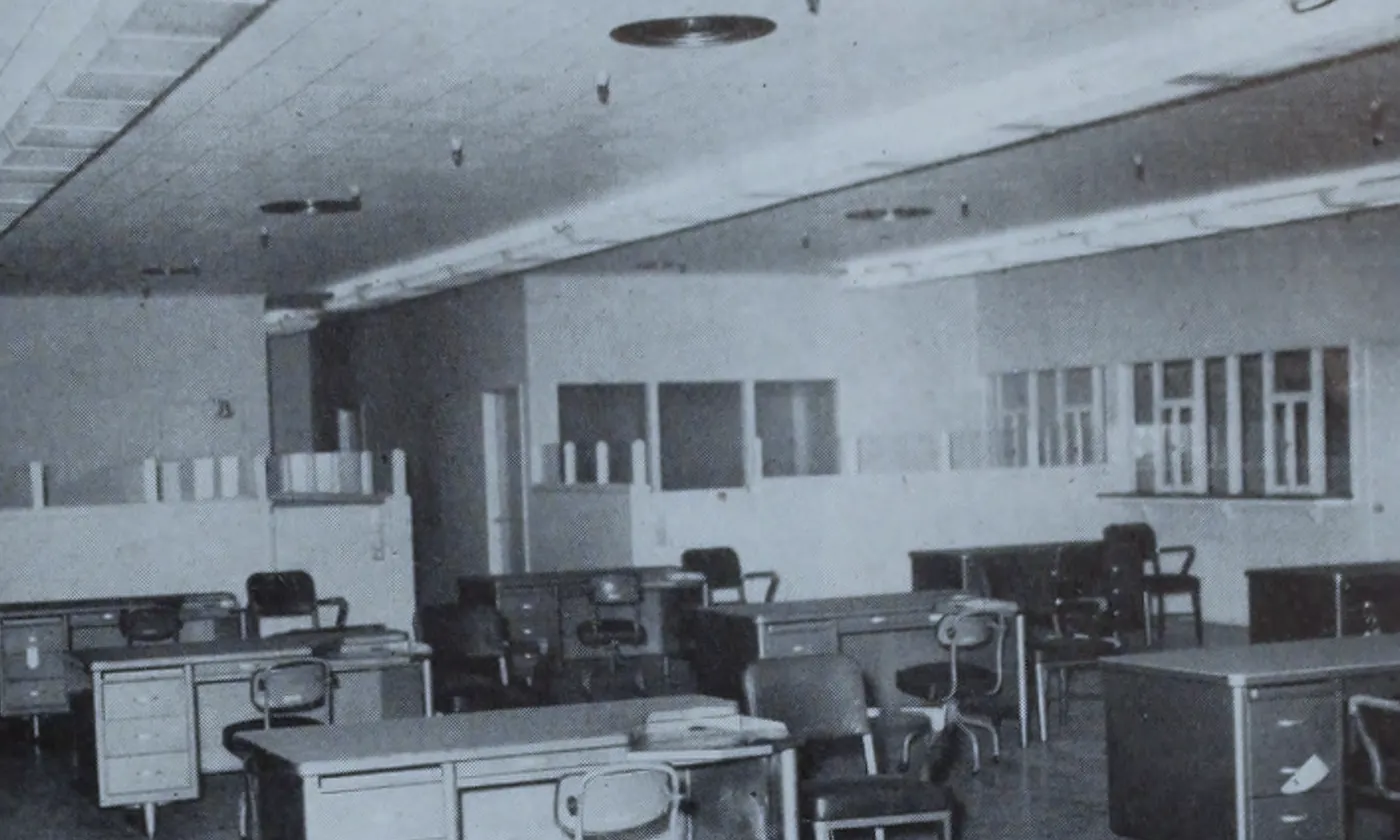 An empty office of desks and file drawers