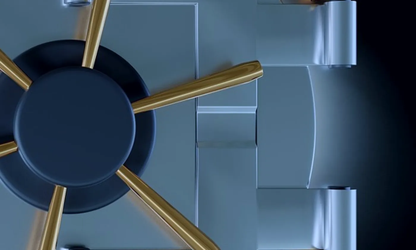 A round steel safe with its wheel and hinges