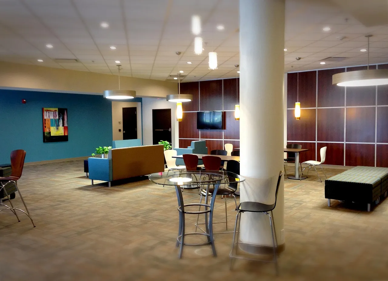 An empty lobby with sofas and tall tables