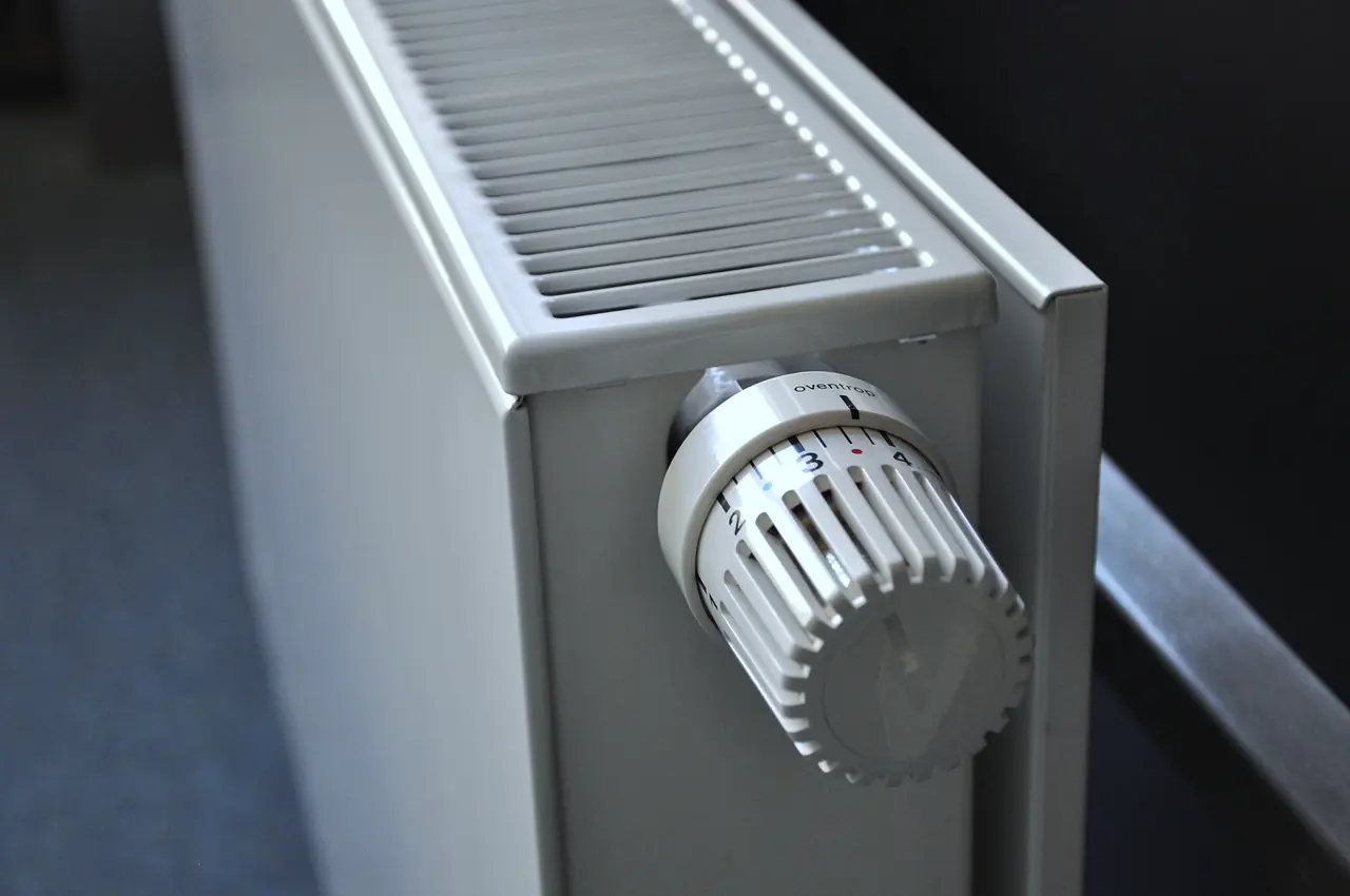 A white panel radiator with a small control