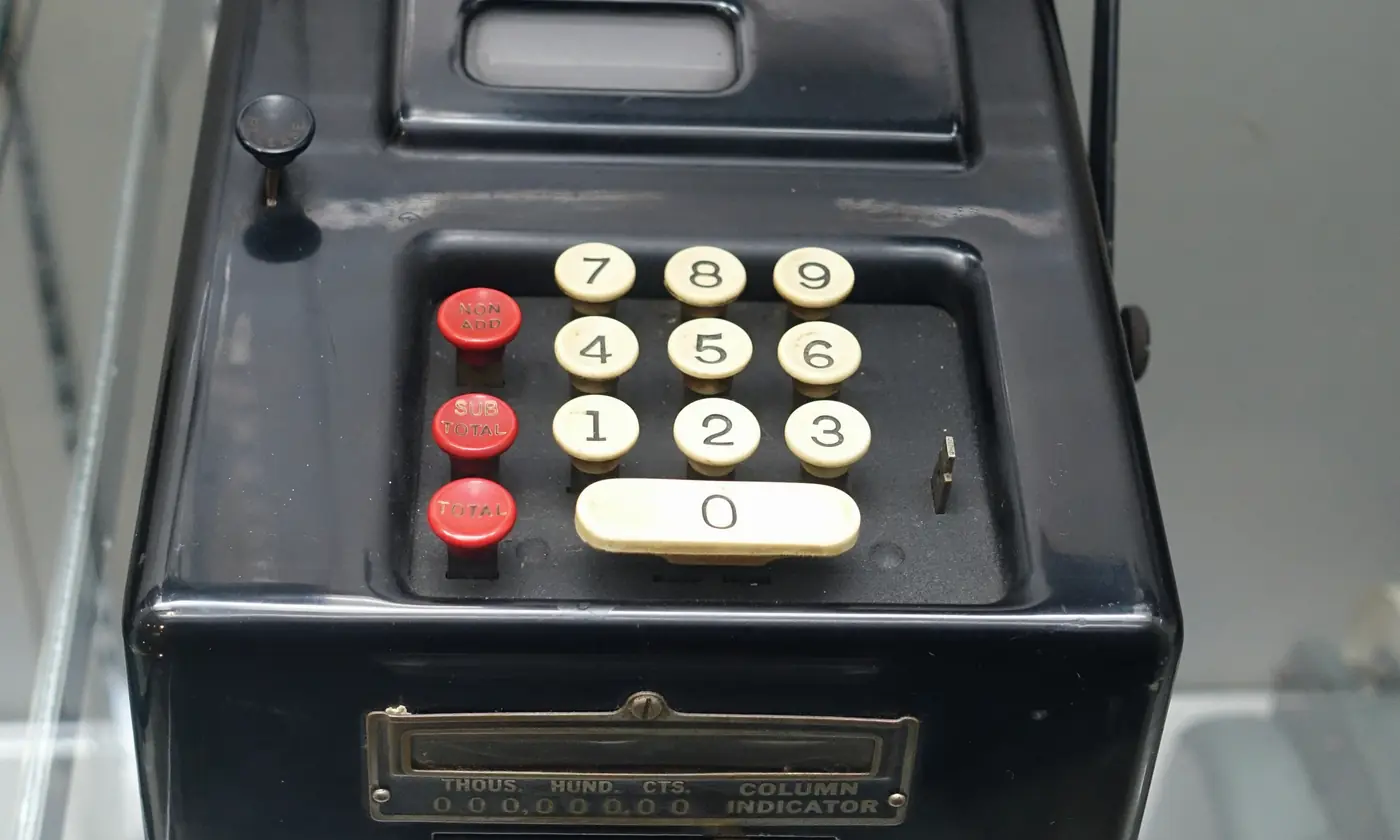 A Remington Rand adding machine, a paper roll above the keys