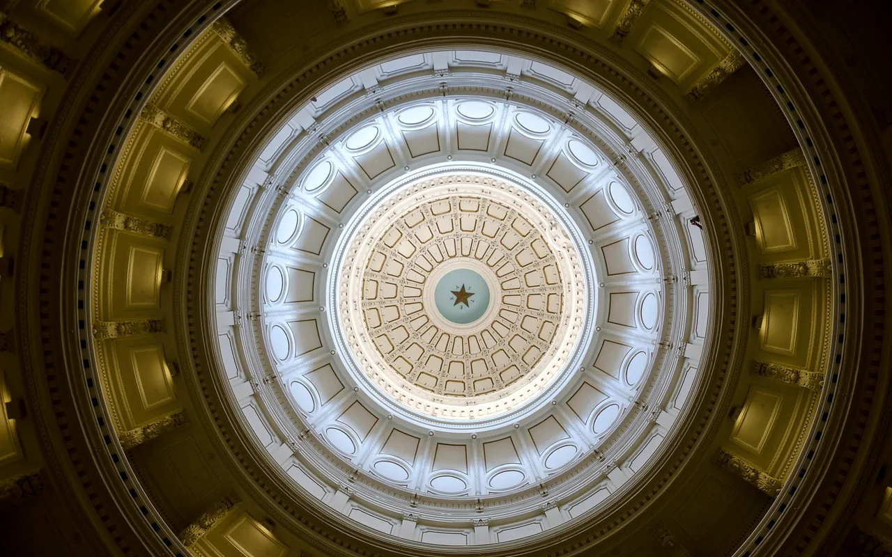 The dome of the Texas State Capitol, seen from below, with a star at the center.