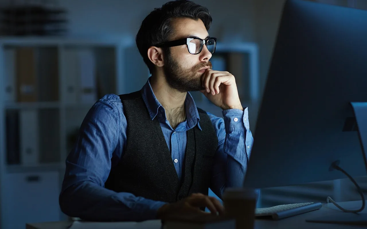 An owner at the screen after dark, here because the company file can wait while the three reports are read.