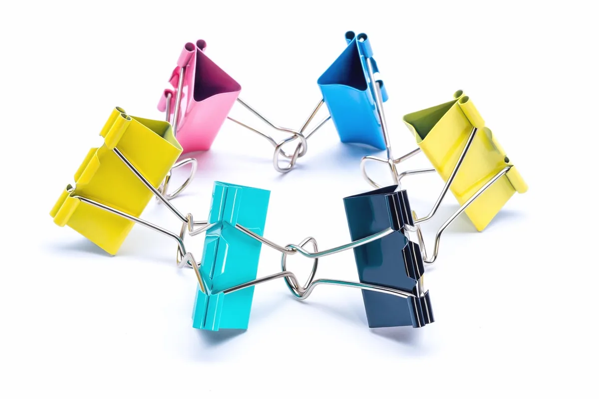 Binder clips on a blank sheet, with no writing.