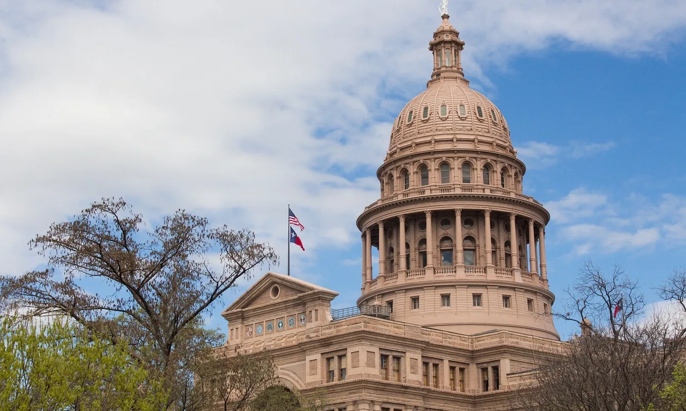 The Texas State Capitol, with the state flag beside the dome
