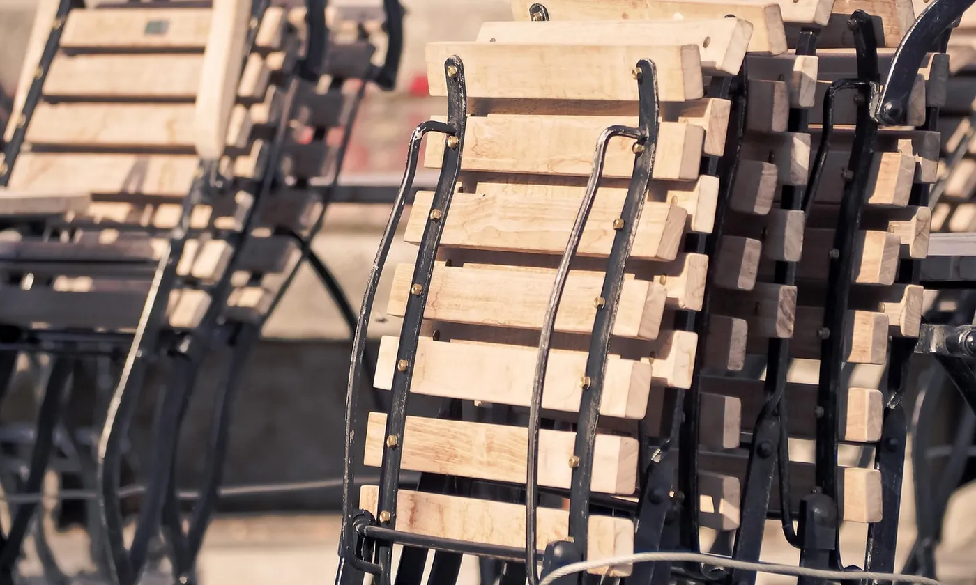 Wooden chairs stacked and locked together after service.