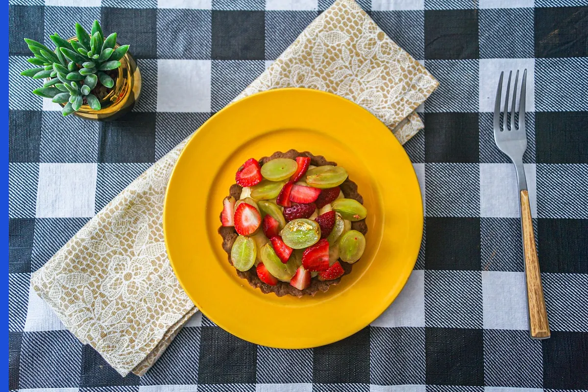 A slice of pie with fruit on a white plate.