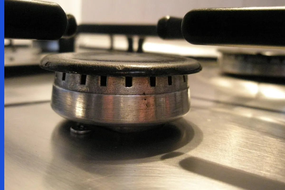 A gas burner with a blue flame and no readable label.