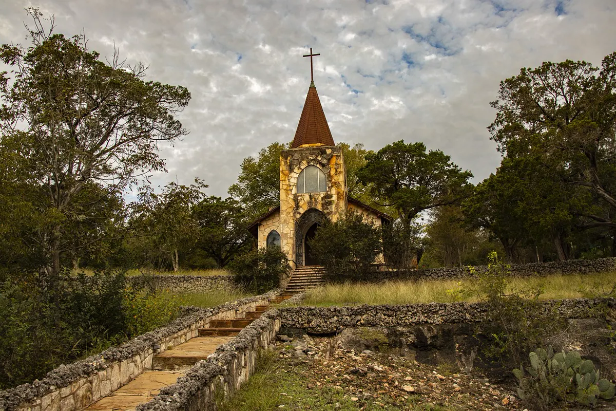 A limestone chapel in the Hill Country, live oaks and prickly pear, no sign and no crowd.