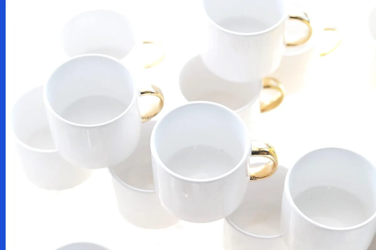 A plain white cup on a pale ground.