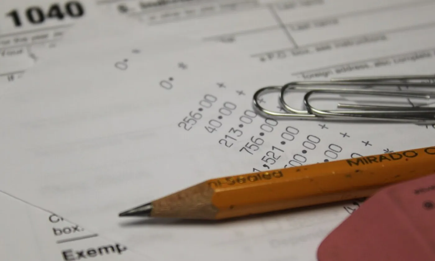 A Form 1040 with a pencil resting on the page.