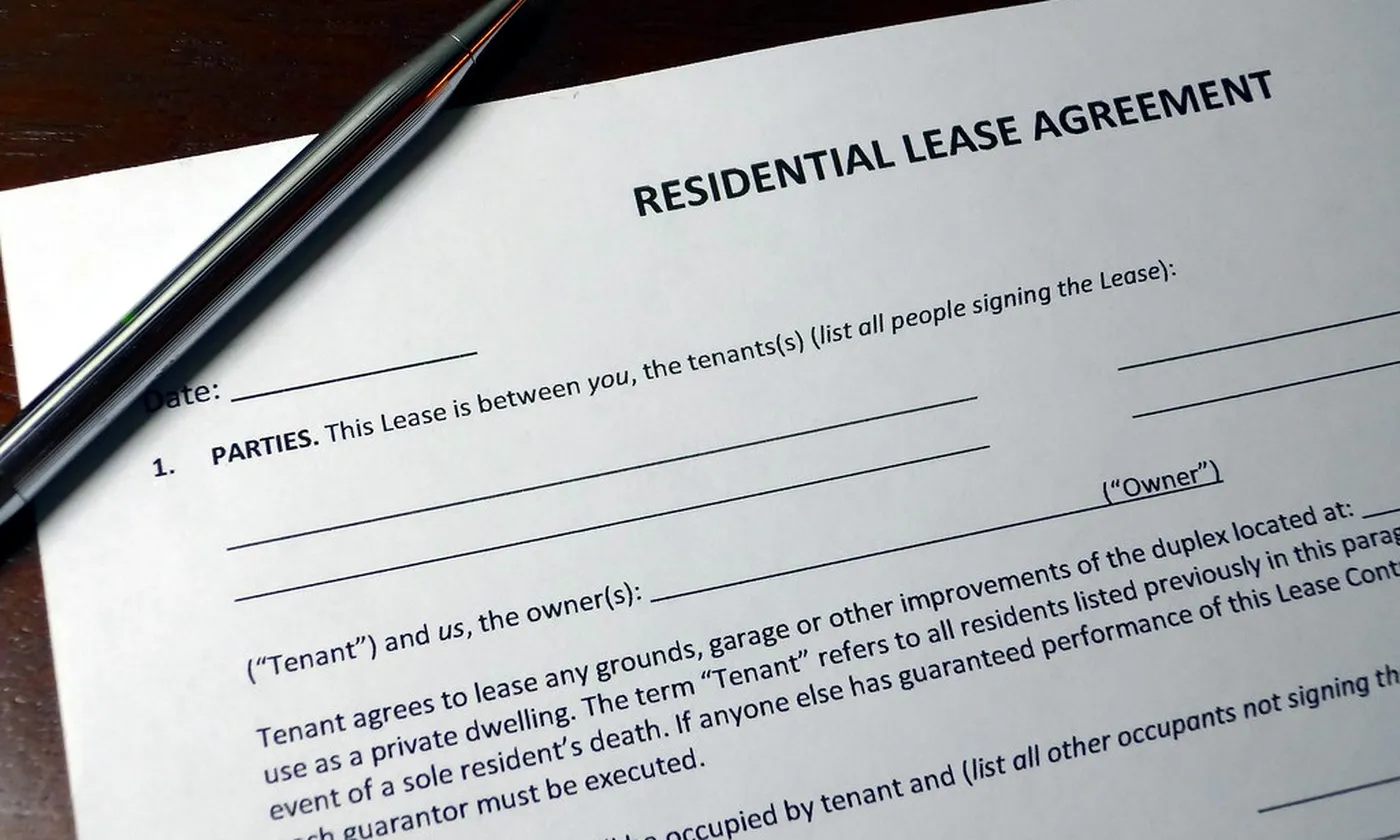A blank agreement with a pen, waiting for a signature.
