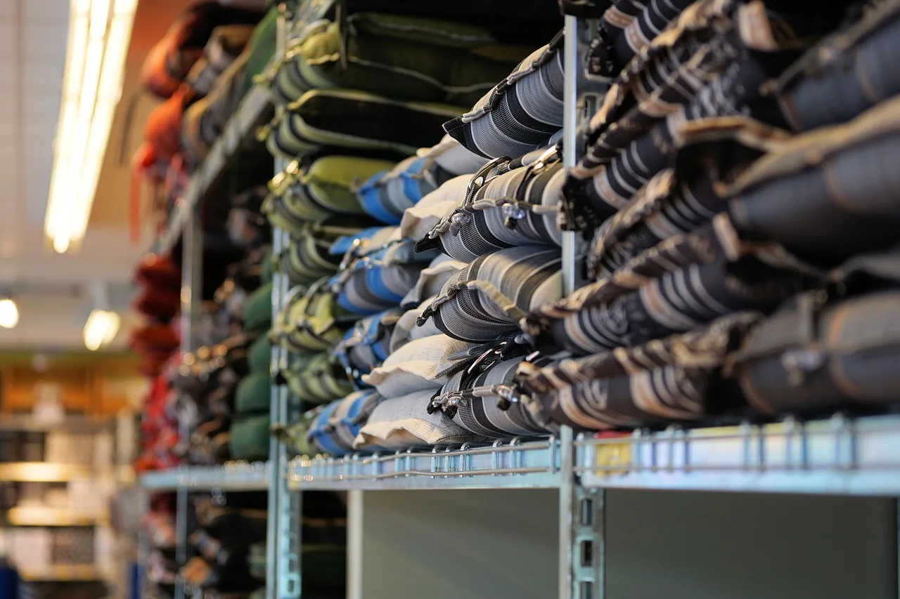 Metal stockroom shelves stacked with bagged merchandise, the shelf side of a count.