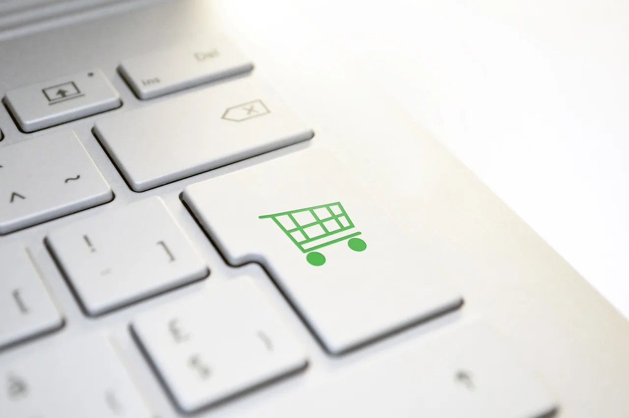 A laptop key printed with a shopping cart, standing in for the online order screen.
