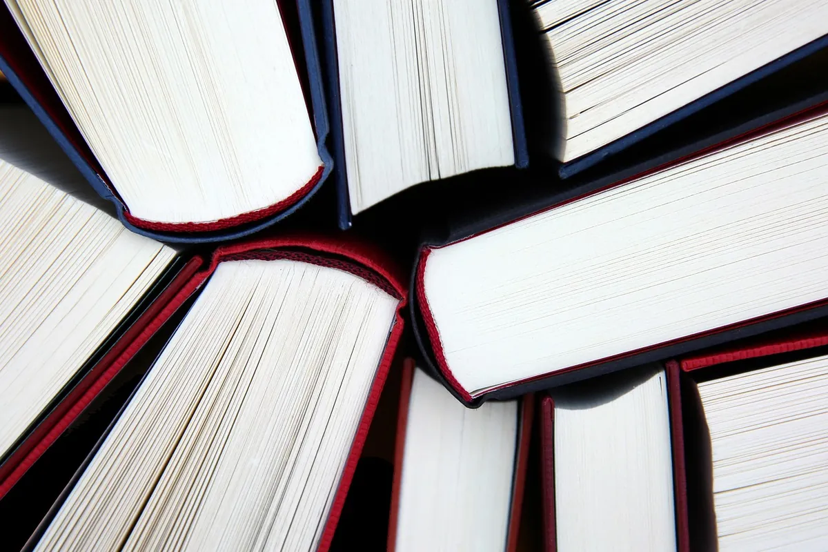 The page edges of several open books