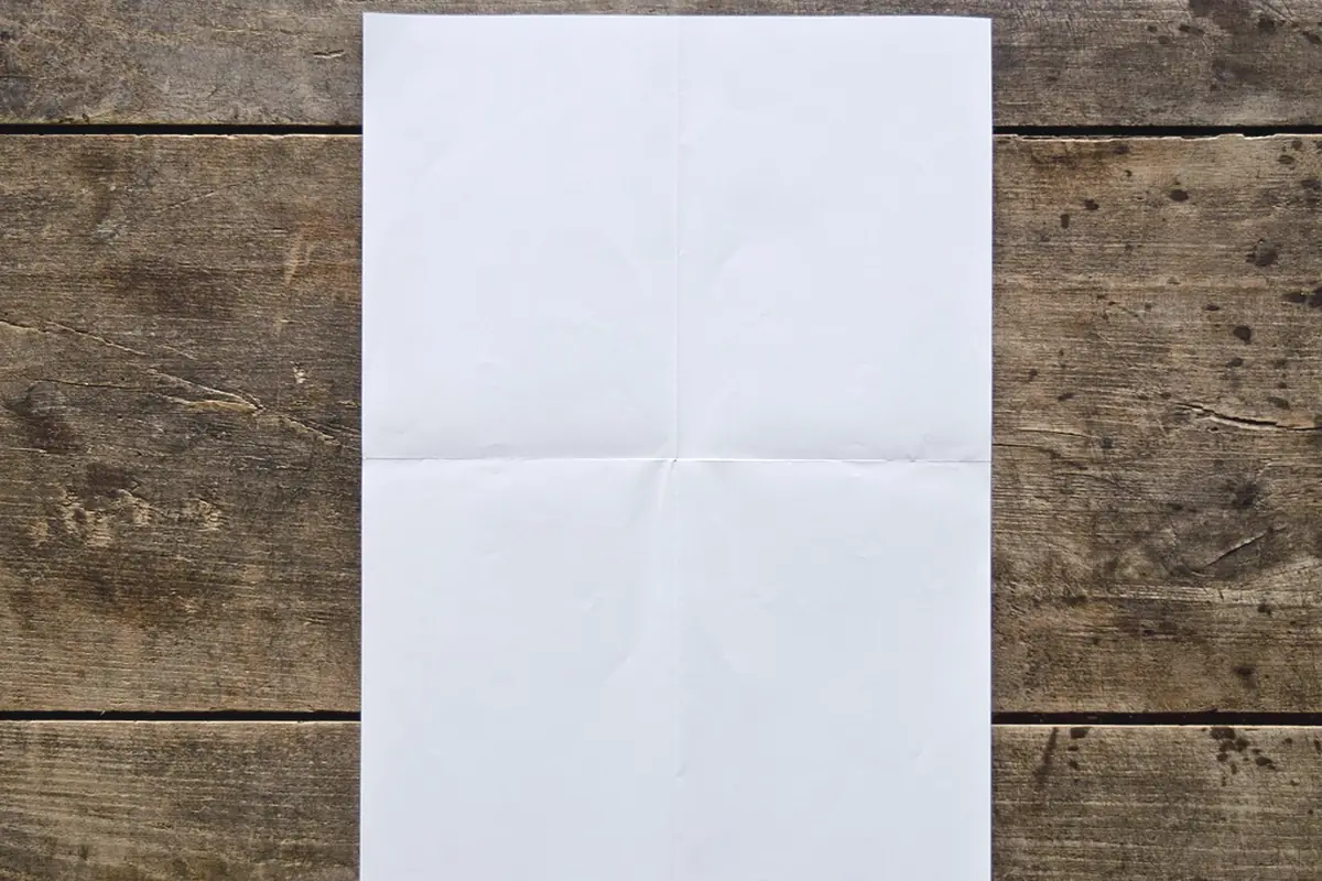 A blank poster leaning on a wood wall