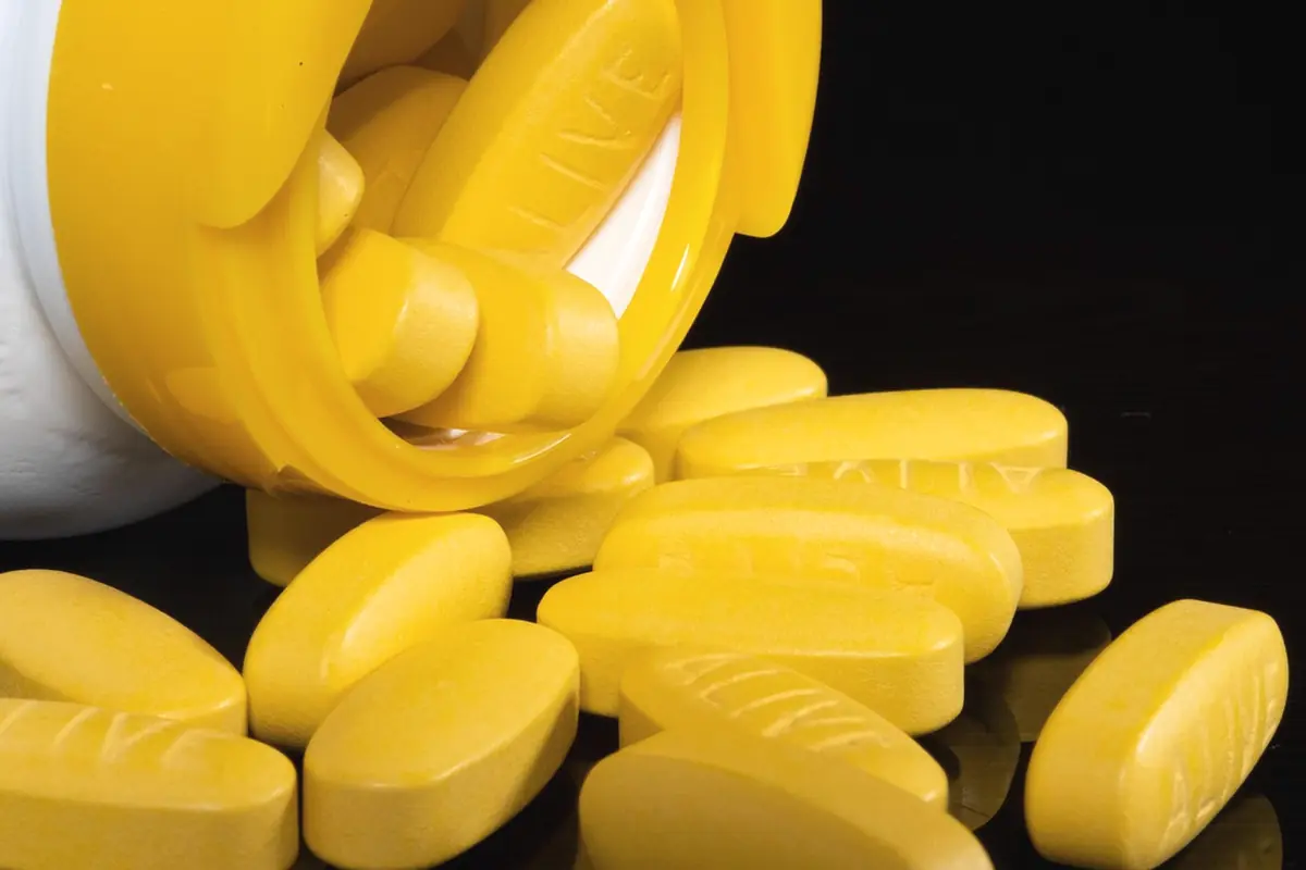 Yellow tablets spread on a white surface